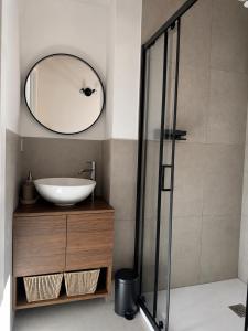 a bathroom with a sink and a mirror at B&B Casa Olivia in Gardone Riviera
