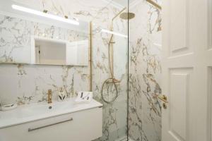 a white bathroom with a sink and a shower at Old Village & Prestige in Vilamoura
