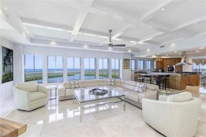 a living room with a couch and a table at Grande Vista Retreat in Naples