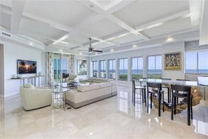 a living room with a couch and a table at Grande Vista Retreat in Naples