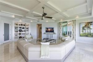 a living room with a white couch and a ceiling fan at Grande Vista Retreat in Naples
