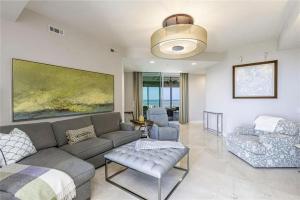 a living room with a couch and a chair at Grande Vista Retreat in Naples