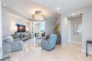 a living room with two chairs and a couch at Grande Vista Retreat in Naples +26 photos