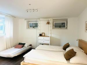 a bedroom with two beds and a dresser at APSTAY Bungalow I Parking option & Self Check-in in Graz