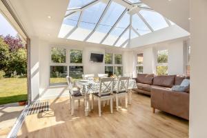 a living room with a table and chairs and a couch at 3 Bed in Reydon oc-brae in Reydon