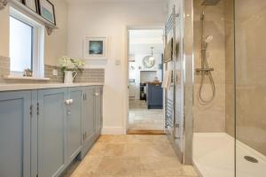 a bathroom with a shower and a sink and a tub at 3 Bed in Reydon oc-brae in Reydon +21 photos
