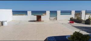 a patio with a table and a view of the ocean at Maison front de mer 2 in Kelibia