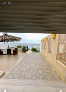 a view of the beach from a building with an umbrella at Maison front de mer 2 in Kelibia