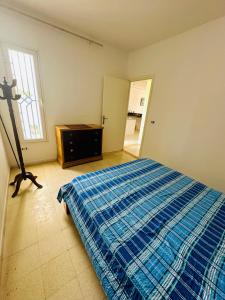 a bedroom with a bed and a dresser and a window at Maison front de mer 2 in Kelibia +2 photos