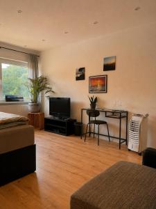 a living room with a table and a television at Haus Johannes in Braubach