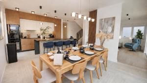 a dining room and kitchen with a table and chairs at Villa Marcello in Zadar