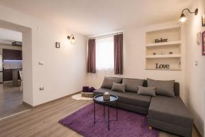 a living room with a couch and a table at App Aurum in Brtonigla +10 photos