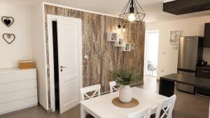 a kitchen and dining room with a white table and chairs at App Aurum in Brtonigla