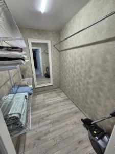 a room with a walk in closet with a mirror at Apartments near border in Narva