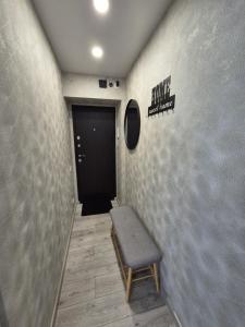 a hallway with a bench in front of a door at Apartments near border in Narva +4 photos