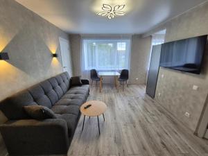a living room with a couch and a table at Apartments near border in Narva
