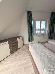 a bedroom with a large bed and a window at Chill & Enjoy in Leopoldsdorf