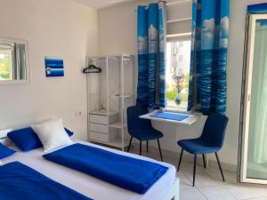 a bedroom with a bed and two chairs and a desk at Apartments Natali in Sveti Petar