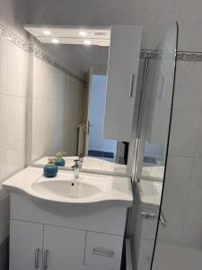 a white bathroom with a sink and a shower at Chill & Enjoy in Leopoldsdorf +15 photos
