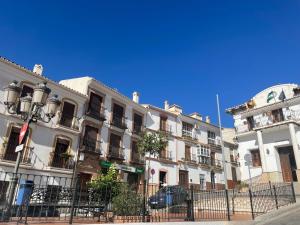 a row of buildings on a city street at Patio de Los Barberos in Valle de Abdalagís +7 photos