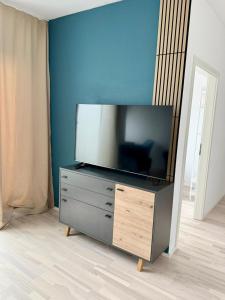 a flat screen tv on a dresser in a room at Chill & Enjoy in Leopoldsdorf