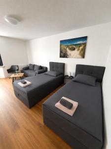a living room with two beds and a couch at Semlow Appartements in Stralsund