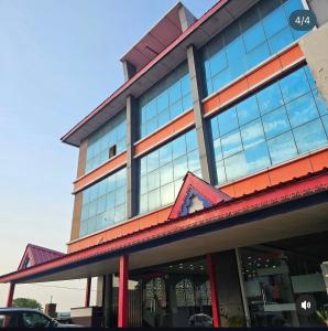a building with a lot of windows at Amar Sweets and Resort in Una