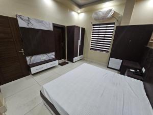 a bedroom with a bed and a tv in it at Amar Sweets and Resort in Una