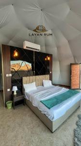 a bedroom with a large bed in a tent at LAYAN RUM LUXURY CAMP & Jeep Tours in Wadi Rum