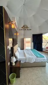 a bedroom with a large bed in a tent at LAYAN RUM LUXURY CAMP & Jeep Tours in Wadi Rum