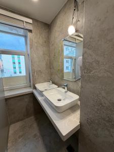 a bathroom with a sink and a window at Mickey central 2 hostel in Ulaanbaatar