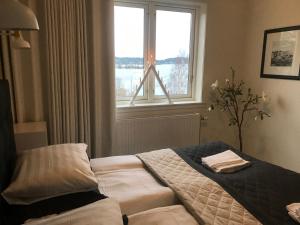 a bedroom with a bed with two towels on it at Sjövillan B&B in Vaxholm
