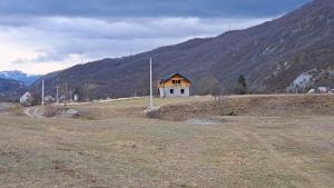 a house on the side of a hill in a field at Brvnara Nikolija in Šavnik