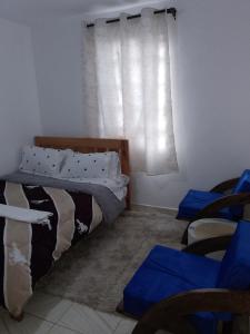 a bedroom with a bunk bed and a window at Kiserian in Kitengela 