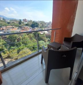 a balcony with two chairs and a view of a city at Great for Relaxing in SC in San Cristóbal
