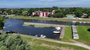 an aerial view of a river with a boat in the water at Rusnės Vėjas in Rusnė