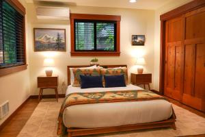 a bedroom with a large bed with two night stands at Elysian at Mount Baker in Glacier