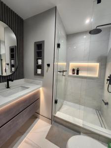 a bathroom with a shower and a sink and a toilet at Executive Room in North York Centre in Toronto