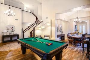 a room with a pool table and a dining room at Lakeside Luxury Val Vista in Gilbert