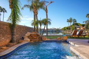 a swimming pool in a yard with palm trees at Lakeside Luxury Val Vista in Gilbert +58 photos