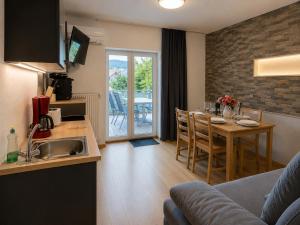 a kitchen and living room with a table and a kitchen and a dining room at Ferienwohnung Wendelstein in Kiefersfelden