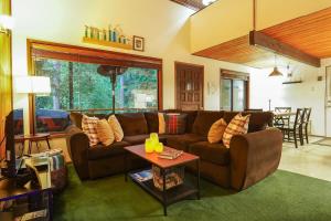 a living room with a couch and a table at Hidden Fern Cabin in Glacier