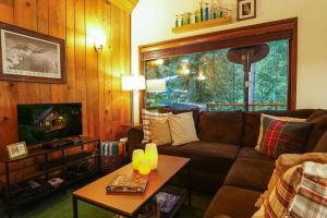 a living room with a couch and a table at Hidden Fern Cabin in Glacier