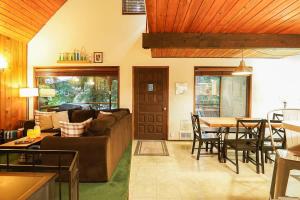 a living room with a couch and a table at Hidden Fern Cabin in Glacier +35 photos