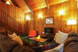 a living room with a couch and a chair at Hidden Fern Cabin in Glacier