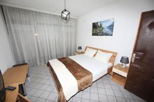 a hotel room with a bed and a desk at Villa Kaya in Ohrid