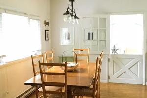 a dining room with a wooden table and chairs at Steps to Beach & Lake Michigan! Family Retreat in Turner Shores