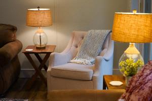 a living room with a chair and a lamp at Kulshan Cabin in Glacier