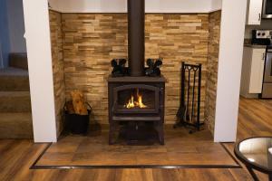 a fireplace in a living room with a brick wall at Kulshan Cabin in Glacier