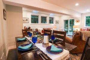 a dining room with a table and a living room at Kulshan Cabin in Glacier